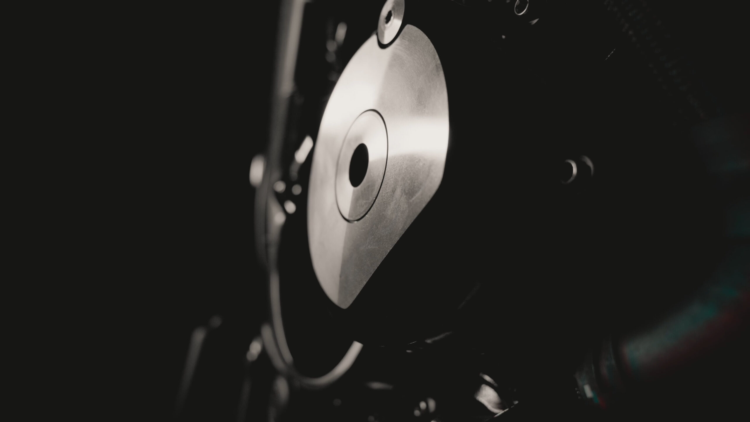 Close-up of a circular silver engine cover set into a dark engine casing.