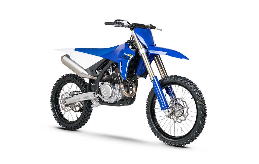 Blue and white ZXMOTO MX250 motocross motorcycle with spoked wheels and knobbly tyres, angled right on a white background.